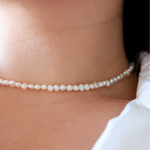 white pearl choker necklace.